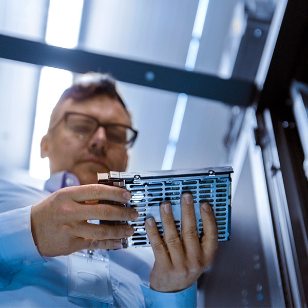 Man holding drive in data center