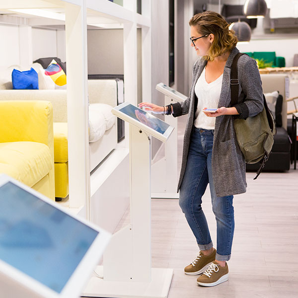 Woman using smart technology in retail store averted gaze