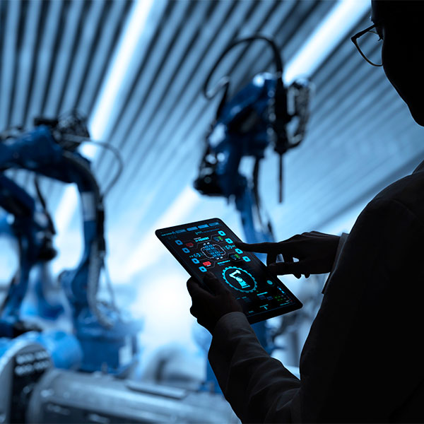 Person using tablet with automation machines