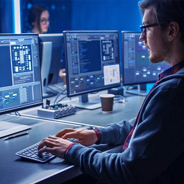 Male engineer at computer desk averted gaze