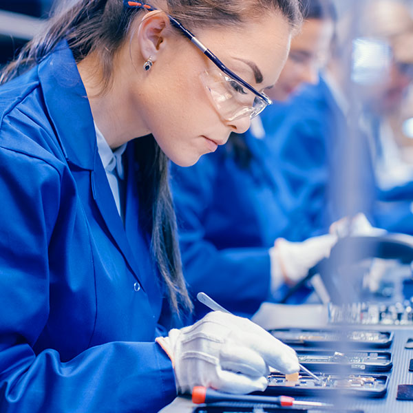 Female technician assembling product averted gaze