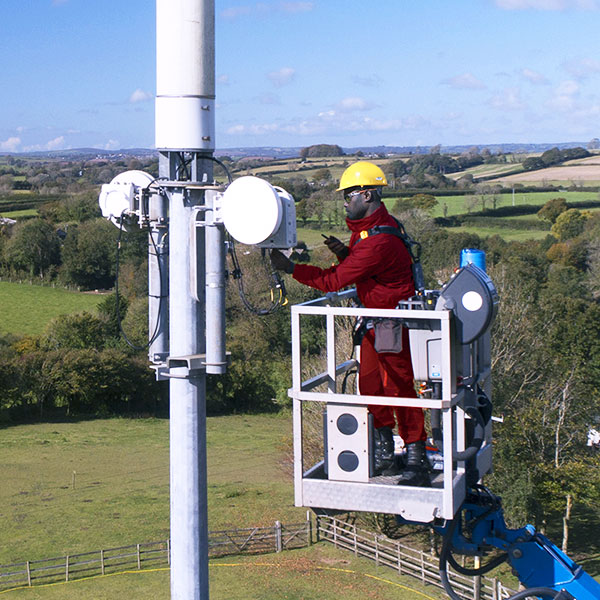 Utility worker on lift performing maintenance