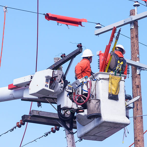 Utility power technicians on lift