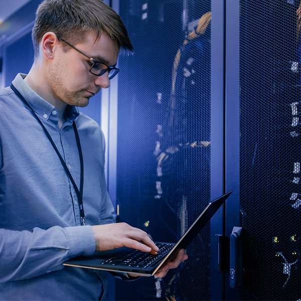 Male technician in data center laptop