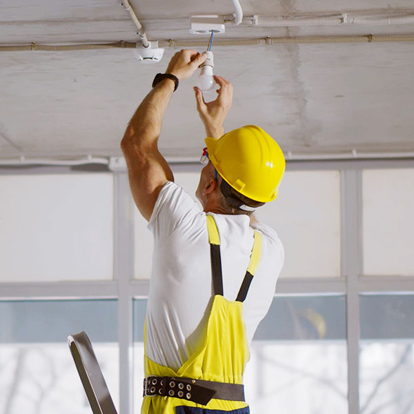 Man installing light in ceiling