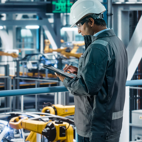 Engineer using remote access control to monitor automation machinery.