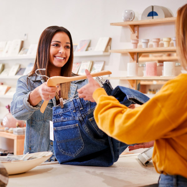 Women making purchase in retail shop under optimal lighting.