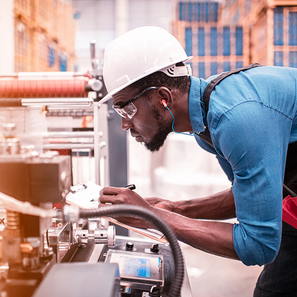 Male technician inspecting equipment at factory