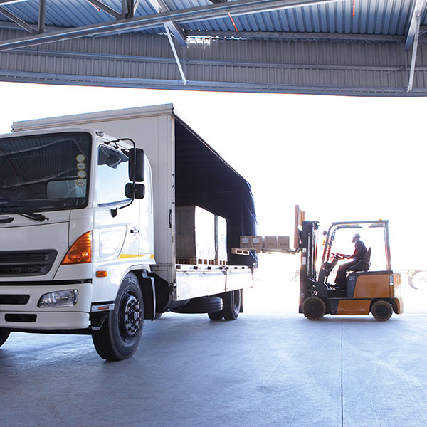 Forklift driver loading delivery truck