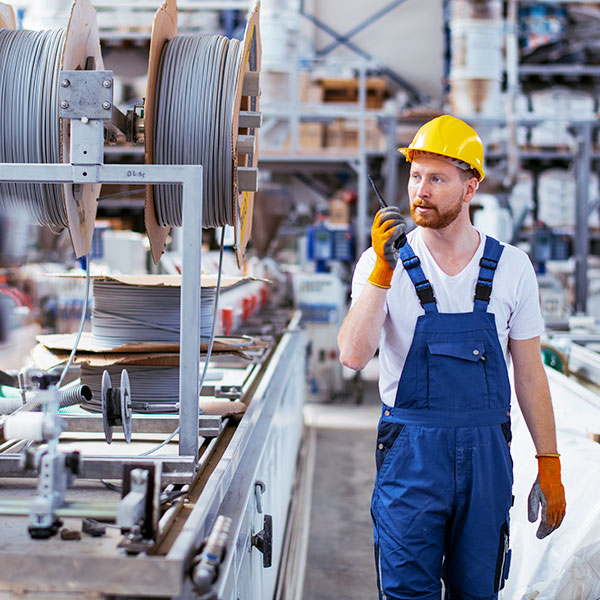 Man with cable reels warehouse averted gaze