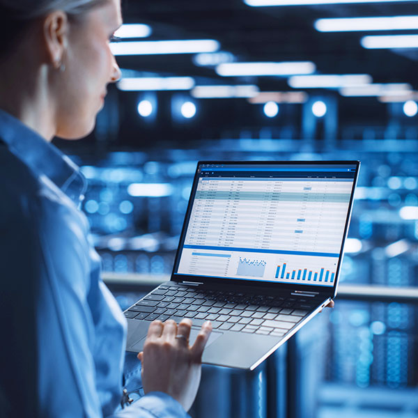 Woman in hyperscale data center with laptop