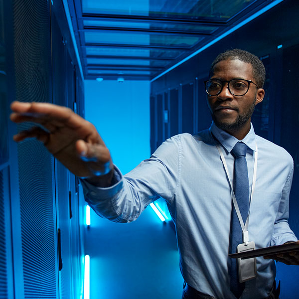 Data center security technician checking servers.