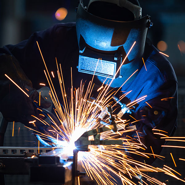 Welder working in face mask