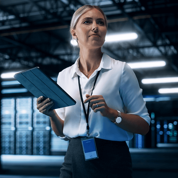 Woman with tablet in data center communication and networking