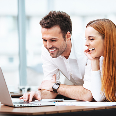 Man and woman using laptop
