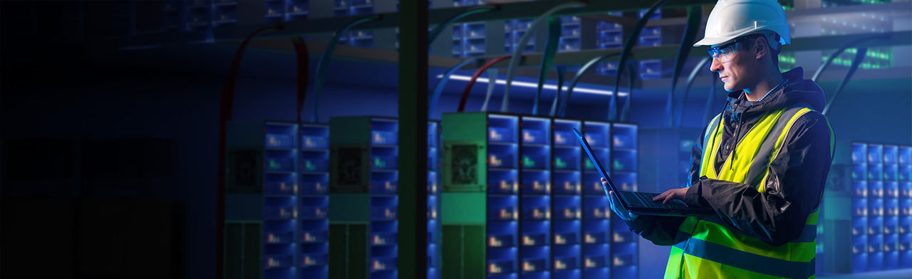 Data center engineer holding laptop