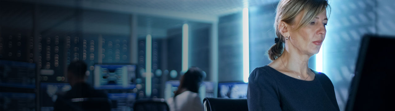 Woman on computer in server room