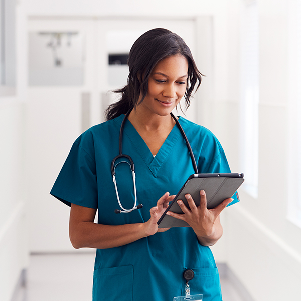Doctor using tablet in hospital hallway