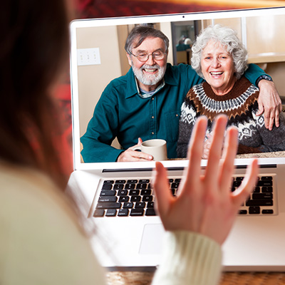 Person on video call with elderly couple