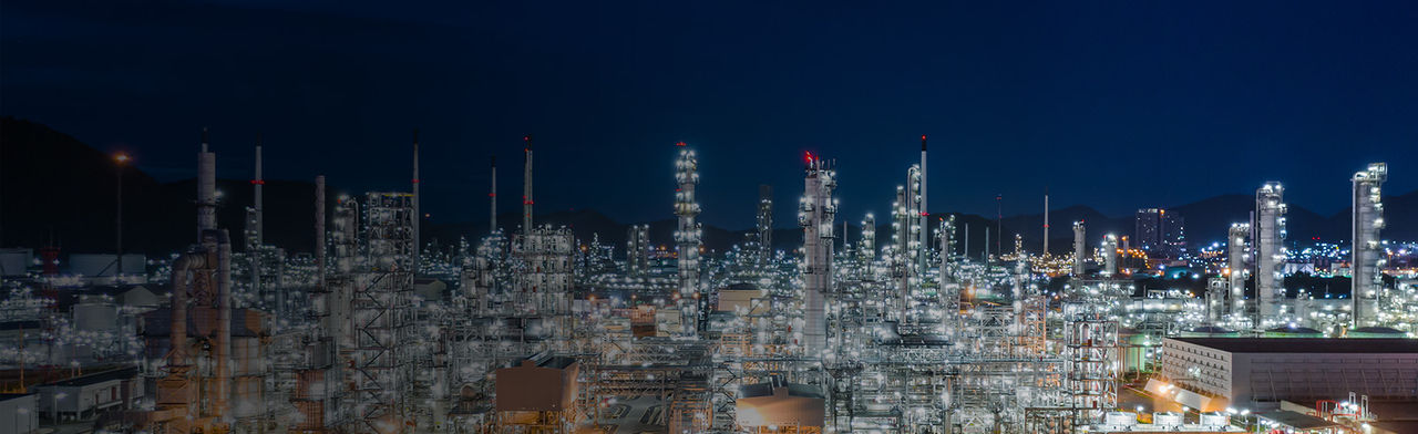 Bright oil refinery at night
