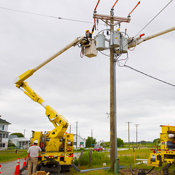 Lineman working on power poles