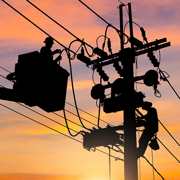 Silhouette of Electrician on a power pole