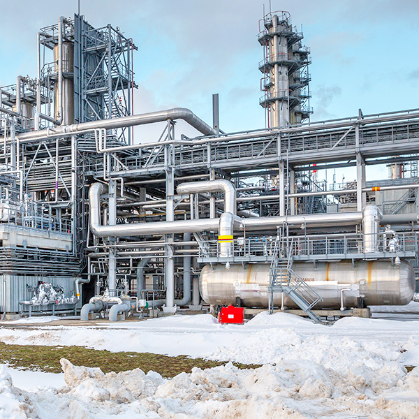 Snow covered industrial plant piping