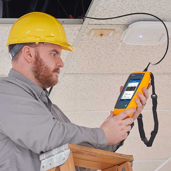 Fluke Technician using handheld device on ladder Solutions