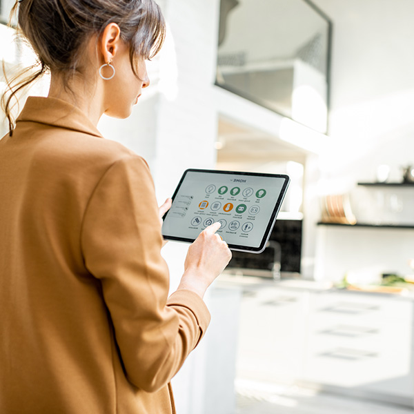 Woman controlling smart home using tablet