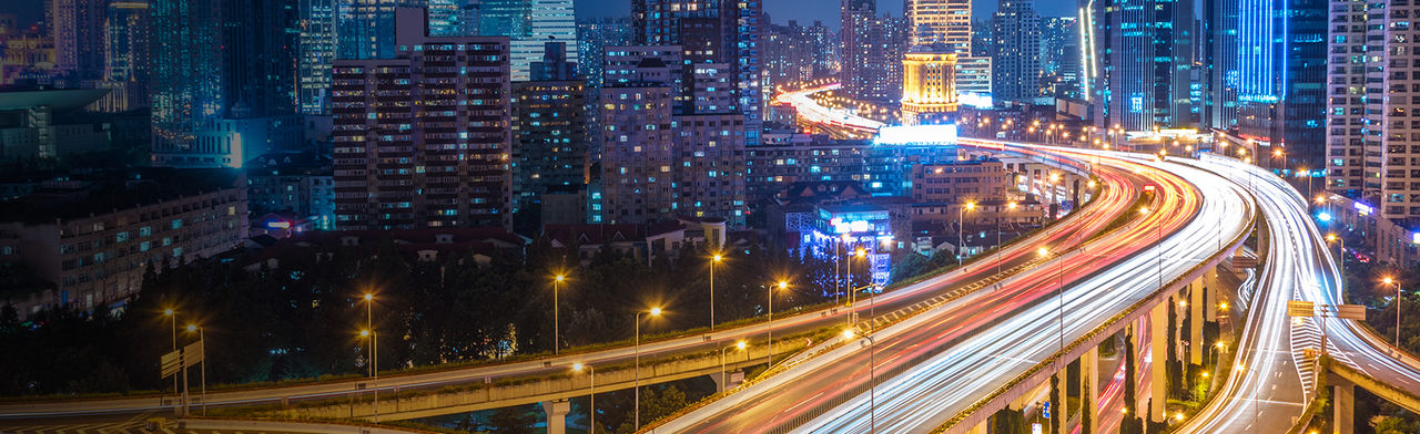 Bright city lights at night aerial view