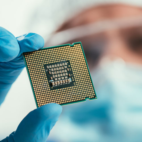 Market selective focus of engineer holding computer microchip