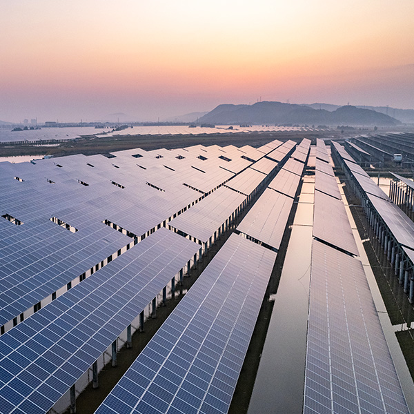 Aerial view of solar panels next to mountains