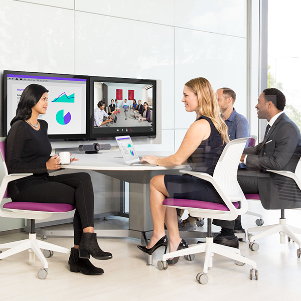 Coworkers collaborating in hybrid meeting