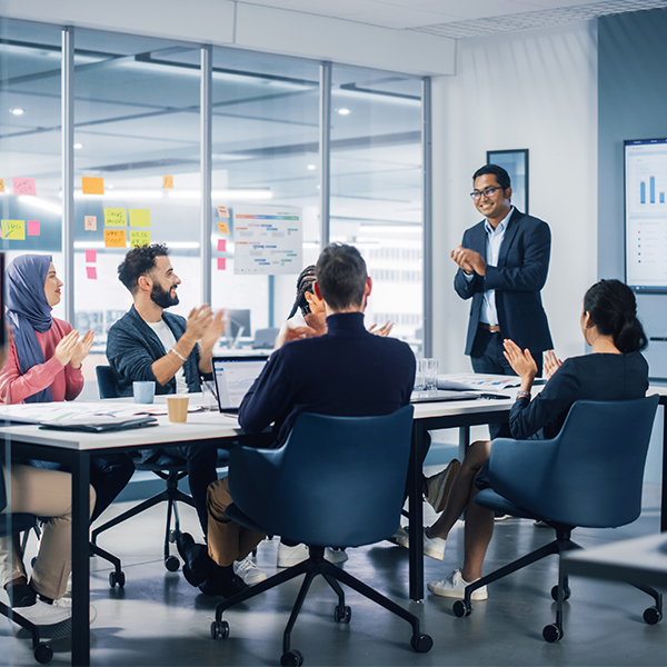 Smiling coworkers in large conference room