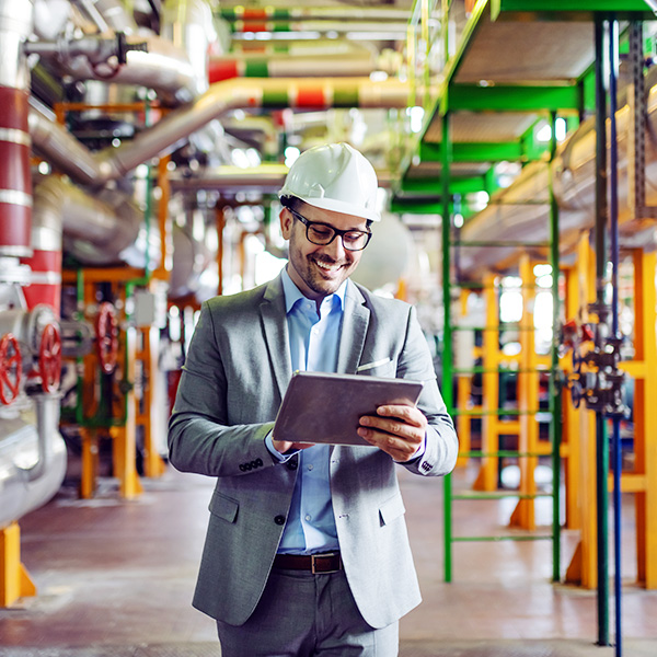 Male worker with tablet in industrial facility