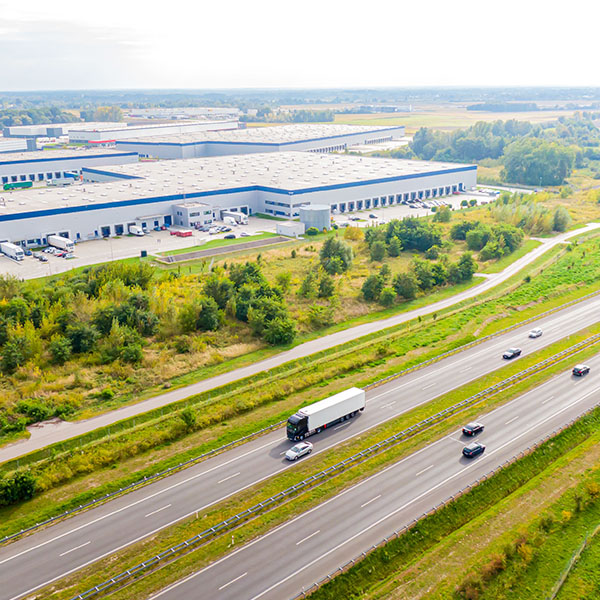 Aerial view of highway next to large warehouse