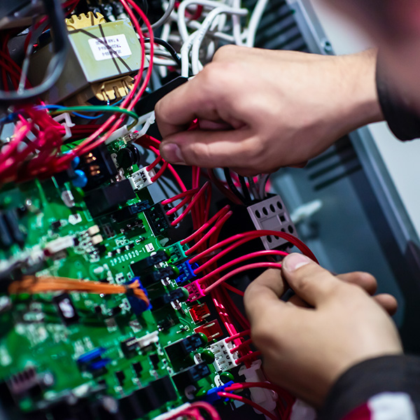 Technician assembling circuit board wires