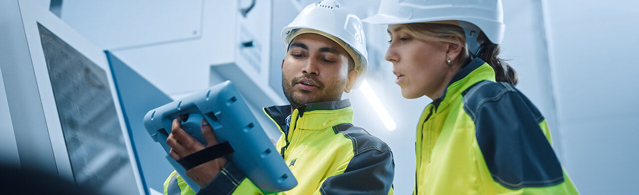 Engineer managers looking at tablet