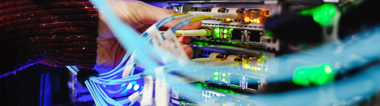 Closeup of person connecting cables to server