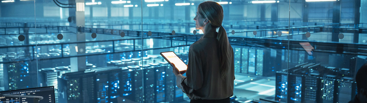 Woman with tablet above modern digital data center
