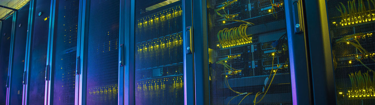Data center racks with colorful lights and cabling
