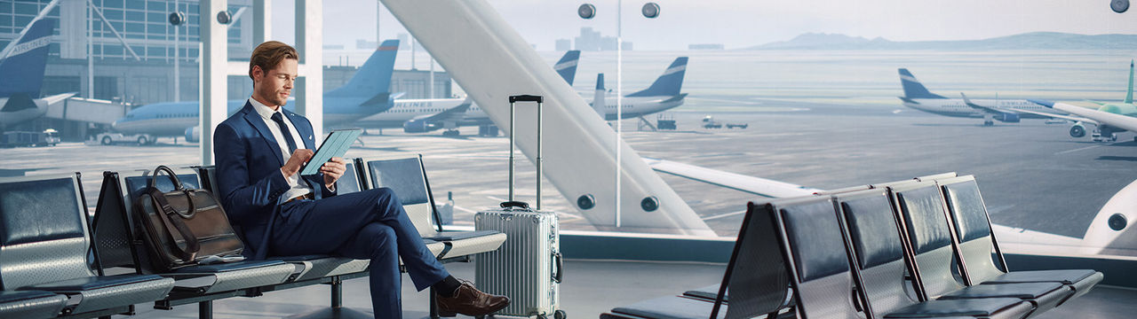 Man using tablet in airport terminal