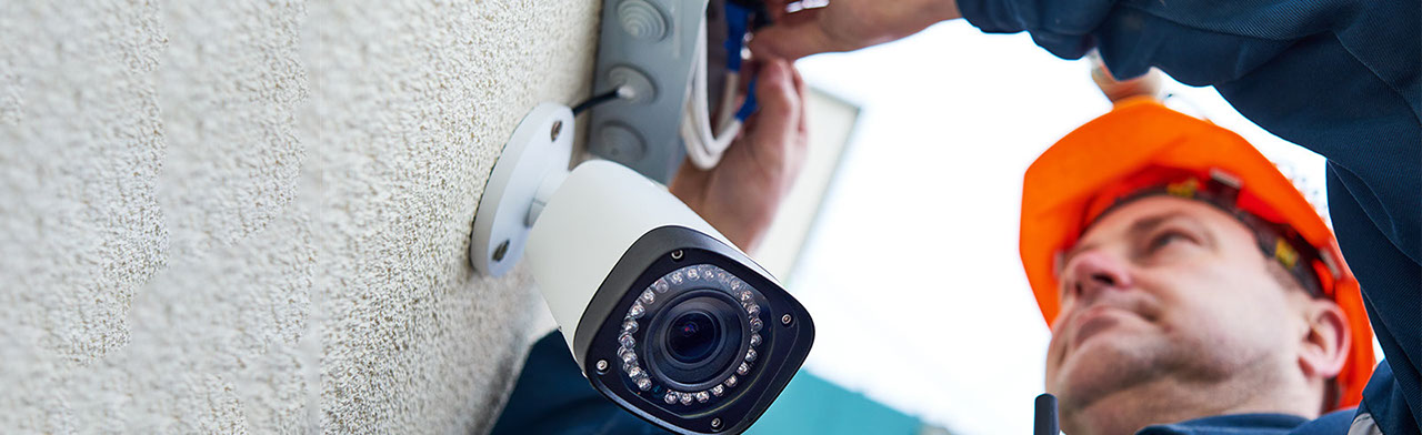 Man installing security camera
