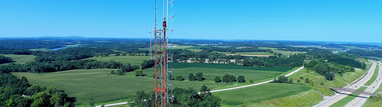 Broadband tower over highway field