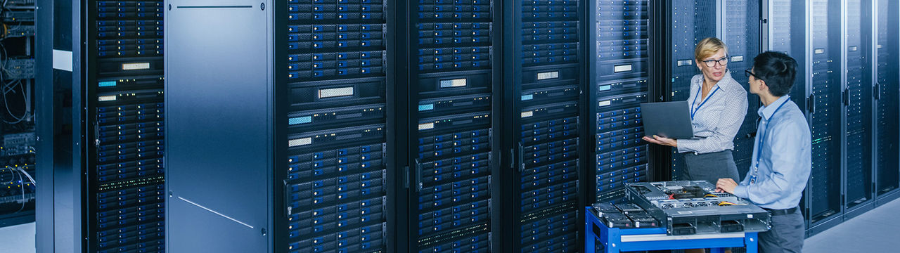 IT technicians inspecting data center racks