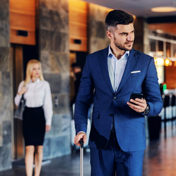 Communications Networking Indoor Wireless Guy in suit on cell phone