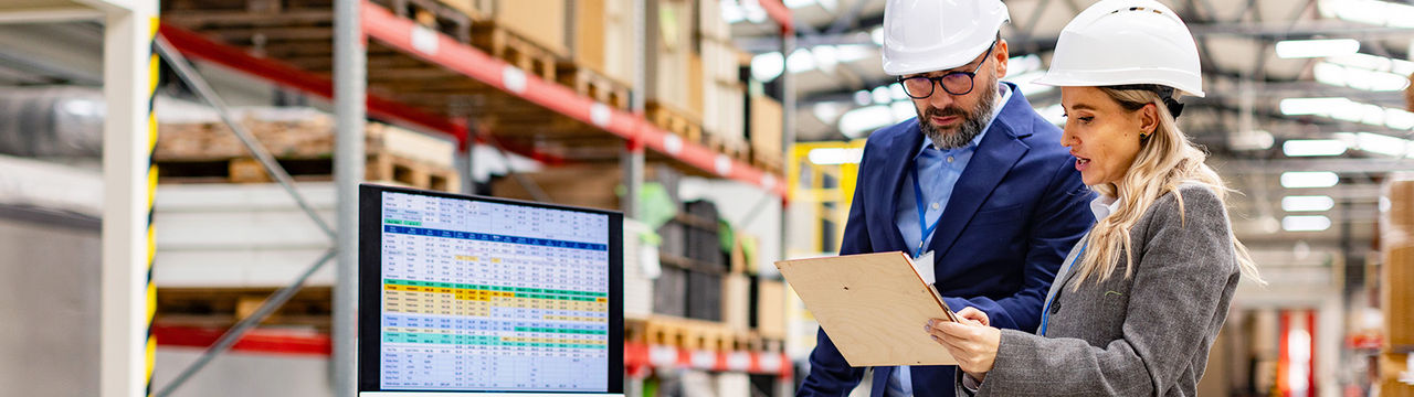 Workers with data screen in modern facility