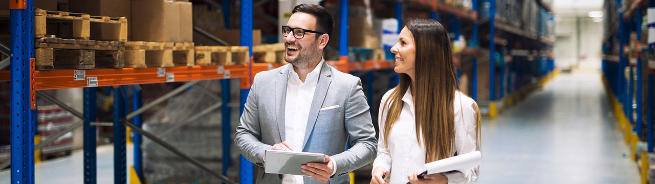 Warehouse managers walking through aisles
