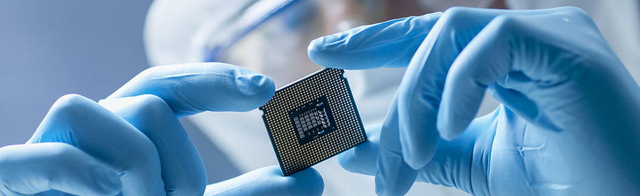 Microchip being held by technician