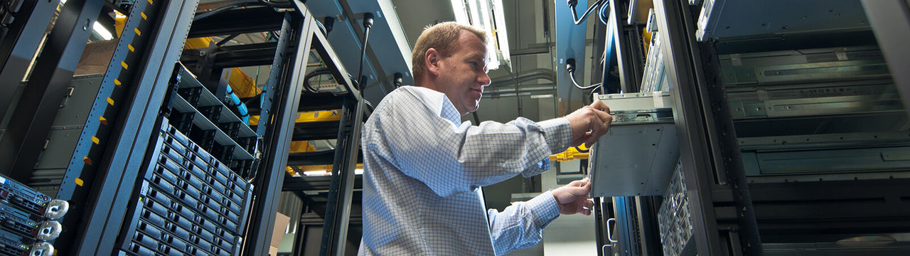IT administrator installing a new rack mount server